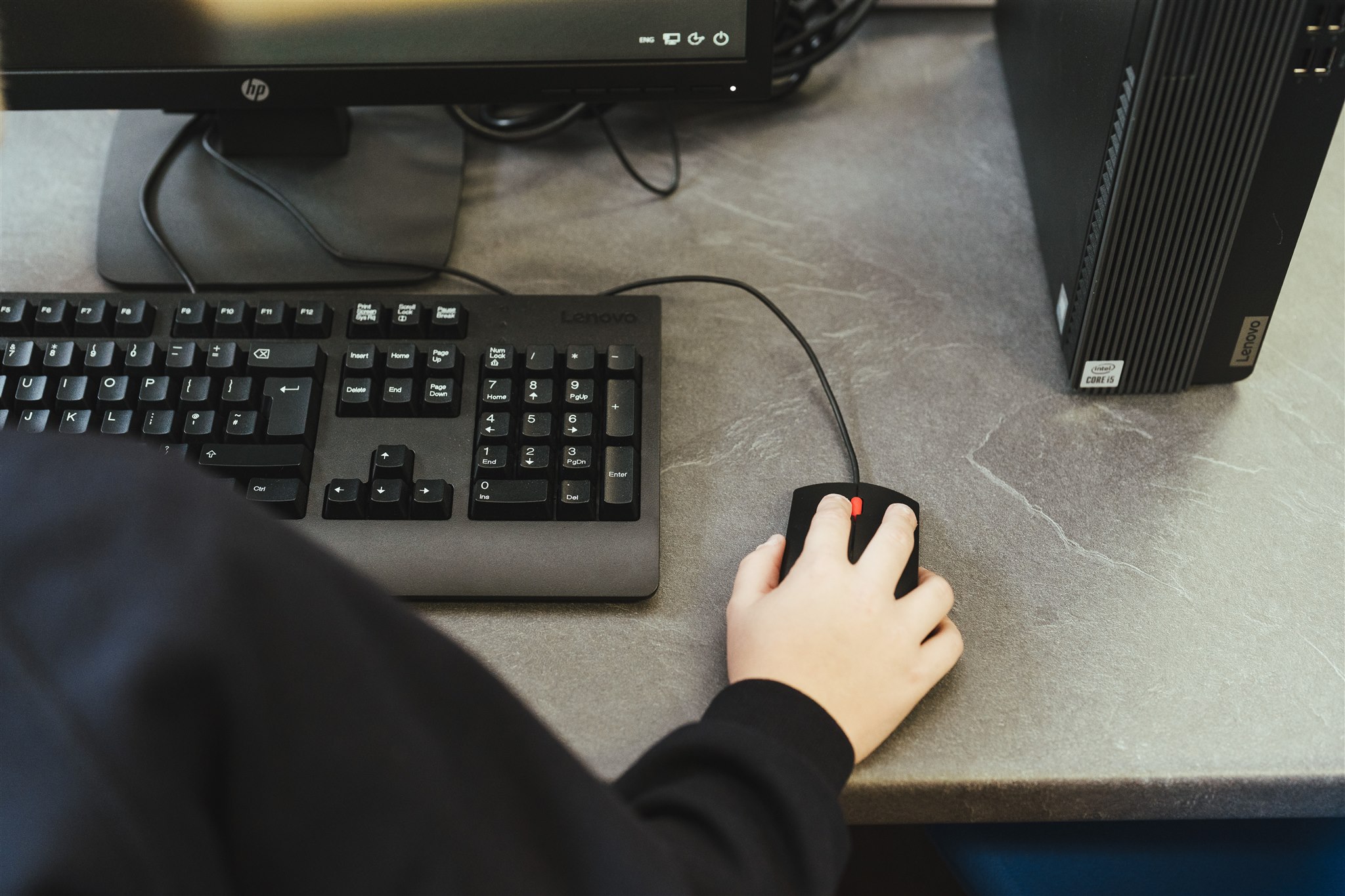 A year 5 student at Staplehurst School using the mouse and keyboard on the school computer.